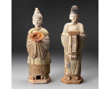 Each modeled standing on a hexagonal base wearing long iridescent green and amber-glazed robes with arms folded in front with