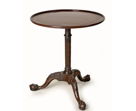 A GEORGE III MAHOGANY TRIPOD TABLEThe circular top with moulded rim, on a fluted support, on acanthus-carved legs, on claw-an