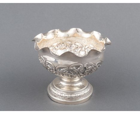 Circular, wavy rim the body embossed with flowers and a heart-shaped cartouche, raised on a circular spreading base, on a rin