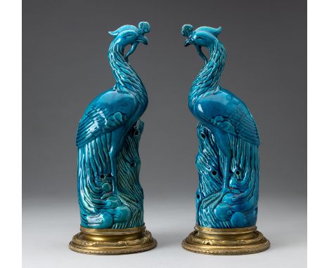 Each brightly enameled blue-green bird perched on pierced rockwork in mirror image, the beak with a Ruyi-shaped comb above an