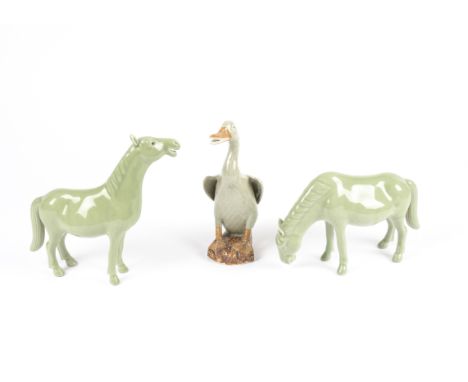 A Chinese celadon glazed figure of a duck with bisque beak, feet and base,  after the Ming Lonquan tradition, with beak sligh