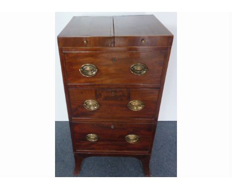 A Regency mahogany commode / washstand,  with double rising top, false frieze drawer above a single and commode drawer, with 