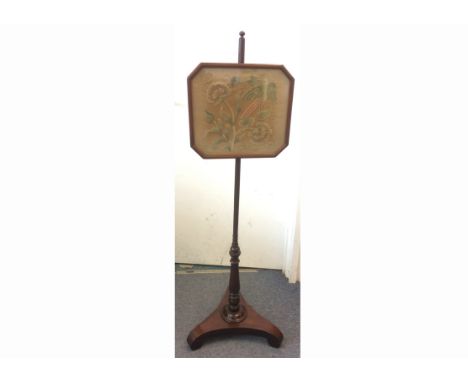 A Victorian rosewood pole screen, with turned support, scroll tripod base, tapestry panel depicting bird of paradise in folia