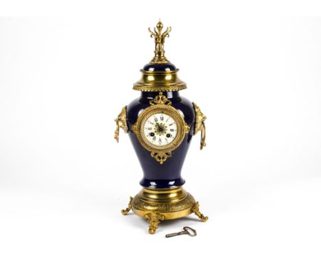 A ceramic ginger jar converted to a clock,  with gilt mounts, on four lions paw feet, the enamel dial with Roman numerals, wi