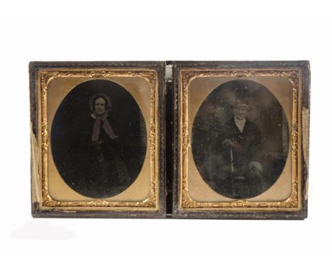 Two Victorian ambrotypes,  the first of a gentleman with top hat and walking stick, the second of a lady with gloves, and tin