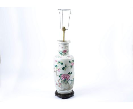 A large late 19th Century Chinese famille rose baluster vase, converted to a lamp, decorated with flowers and blossom, upon a