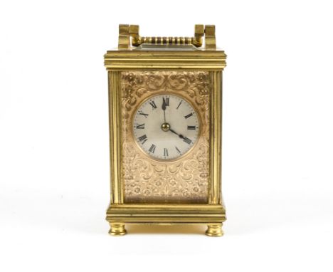 A c1900 brass carriage clock,  in exhibition case, the dial with Roman numerals and highly attractive profusely decorated met