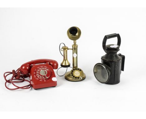 A 1967 706 red telephone, together with a vintage styled brass candle phone, with a rotary dial and retailed by GEC and a cas