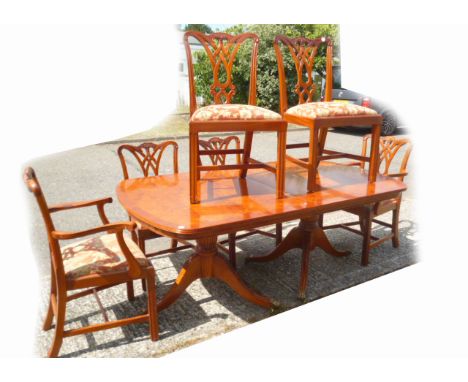 A contemporary yew wood dining suite, with twin pedestal table, on tripartite bulbous column supports, lion paw caps and cast