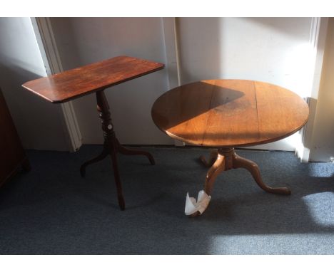 Two 20th Century tripod tables, one mahogany with a rectangular top, top 64cm x 47cm, height 74cm, the other oak with circula