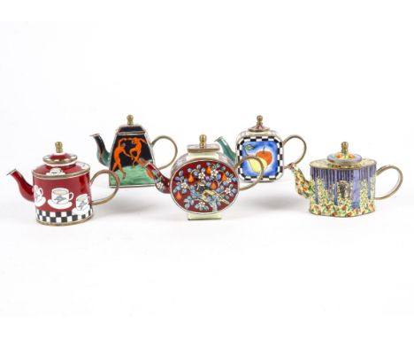 A collection of Trade Aid teapots with hand painted enamel decoration, each individual piece reflecting decorative arts tradi