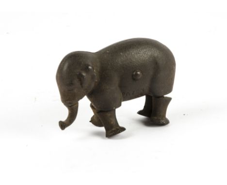 A novelty cast iron walking elephant,  likely Edwardian era bearing impressed marks 'Patent 1873', with both articulated legs