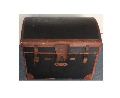 An Early 20th Century travelling trunk, domed structure with leather bindings, lined with an interior tray, 68cm x 51 cm x 66