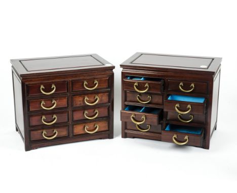 A pair of Chinese hardwood jewellery chests of small proportion,  each having eight partially fitted short drawers with loope
