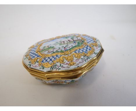 A late 18th/early 19th century silver gilt and enamelled cartouche shaped patch box, decorated with a river scene, castle, fi