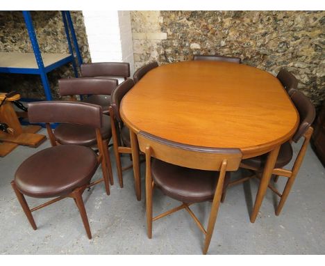 A G-Plan teak extending dining table on turned, tapered legs, 29 high, 65 1/2 long and a matching set of eight chairs, each w