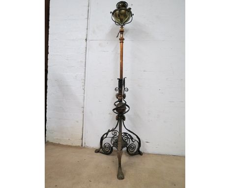 A late Victorian copper, cast brass and wrought iron standard lamp with a removable reservoir, a height adjustable column wit
