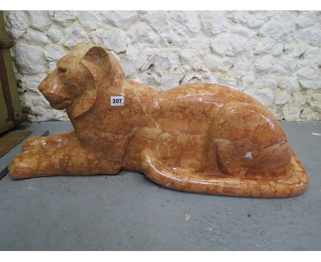 A Michael Cooper carved, mottled brown marble model of a recumbent lioness, 13 high, 32 long