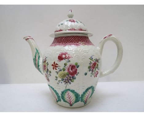 An 18th century Staffordshire porcelain teapot decorated with floral sprays in polychrome colours above a band of styalized l