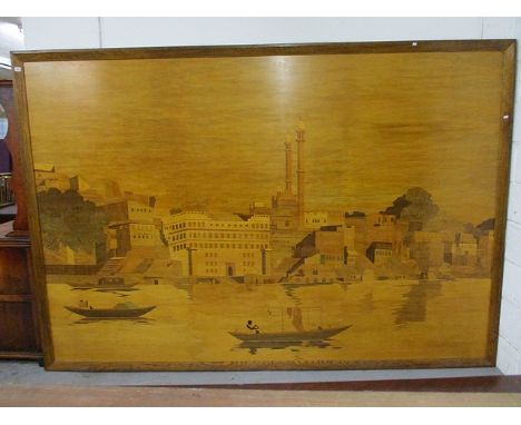 A 1930s marquetry panel depicting an Asian river scene with figures in boats, buildings and a temple on the bank, 75 x 111 in