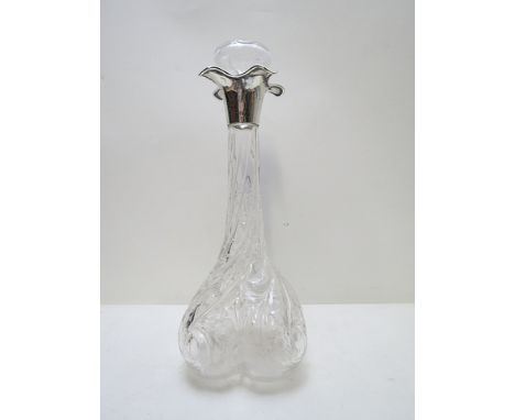 An Edwardian crystal decanter of lobed, square form with wrythen, foliate and floral cut decoration and a silver quatrefoil c