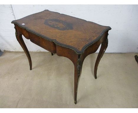 A late 19th century continental tulip wood and marquetry table with a central floral panel and cast metal edge, over a drawer