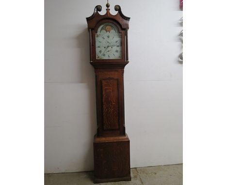 A George III mahogany veneered oak longcase clock, the hood with a swan neck pediment and reeded columns over a door and box 