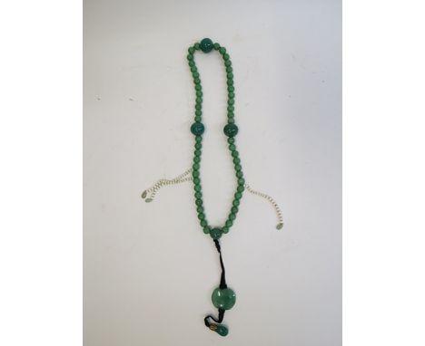 A Chinese jade and green stone mandarins collar with oval and teardrop pendant