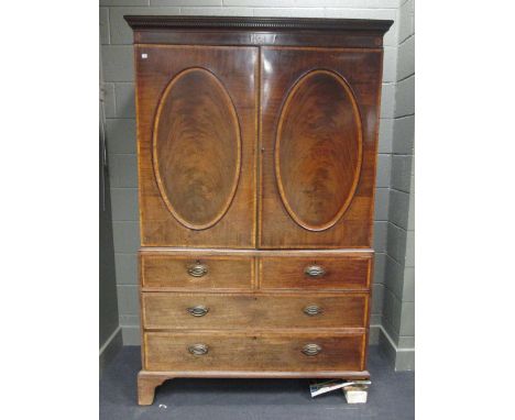 A George III mahogany linen press, with sliding shelves above two short and two long drawers on bracket feet, 199 x 125 x 60c