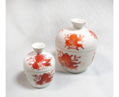 Two 19th century iron red bowls and covers, with shou ideogram, bats and pomegranates, 12cm high, the smaller bowl with pomeg