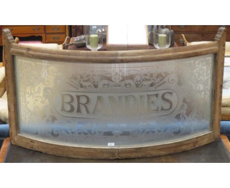 A Victorian pine framed bowed frosted glass panel, "BRANDIES" 70 x 120cm  