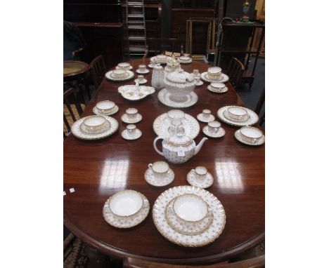 An extensive Spode dinner service, Fleur de Lys Gold pattern, decorated in gilt on an ivory ground  