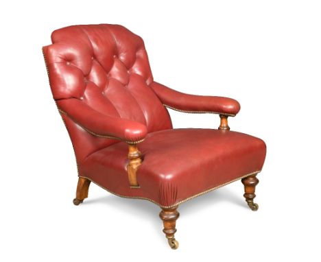 A 19th century mahogany gentleman's library armchair, button upholstered in red leather, on turned legs and brass casters 88 