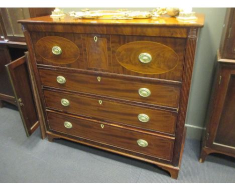 A Georgian mahogany secretaire chest with line inlaid decoration, the secretaire drawer inlaid with oval panels centred by a 