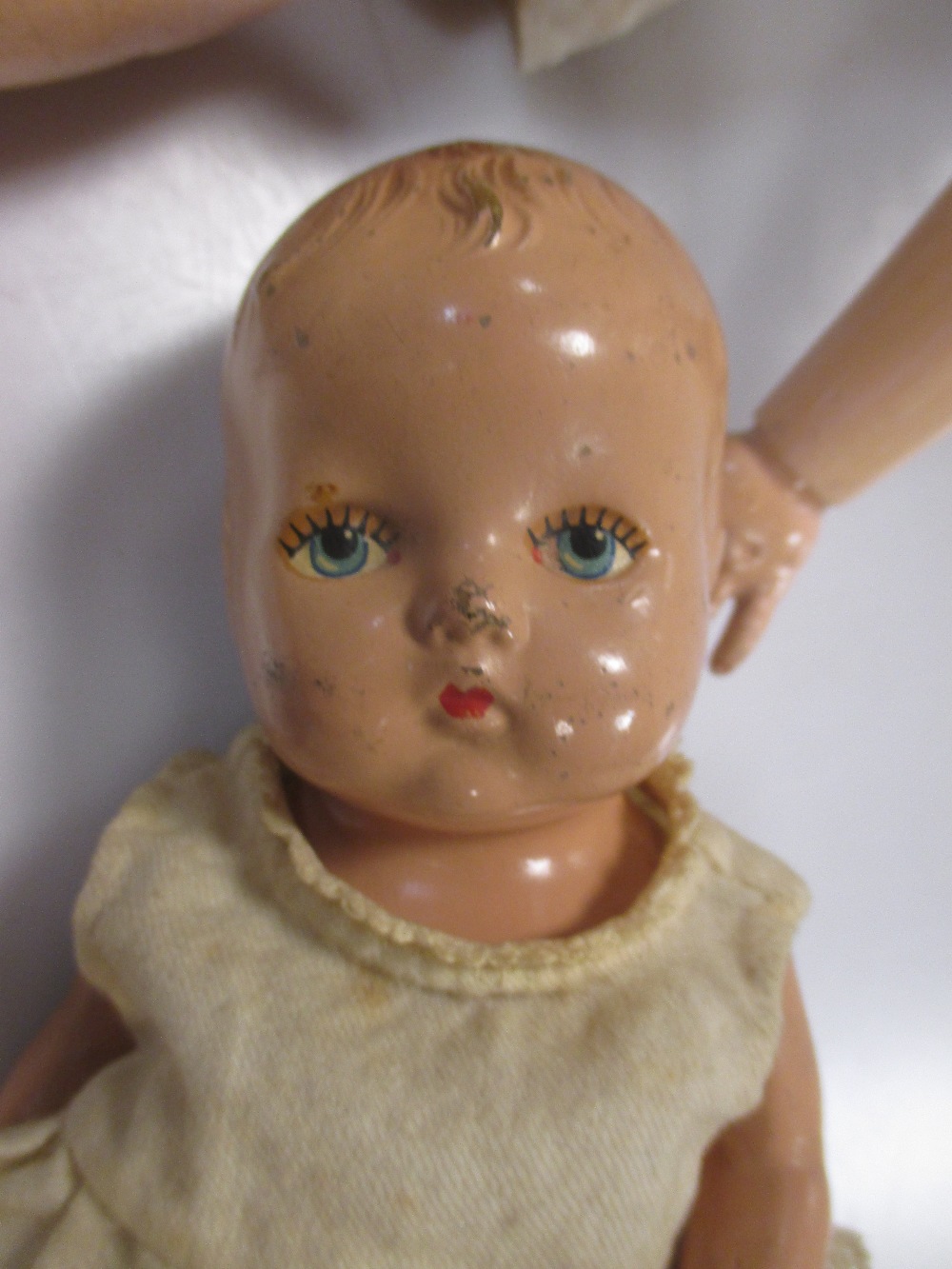 Three bisque head dolls and a composition head baby doll (4) in