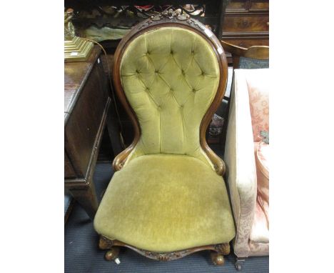 A Victorian button upholstered open arm easy chair with foliate carved and showwood frame, scroll arms and cabriole legs, and