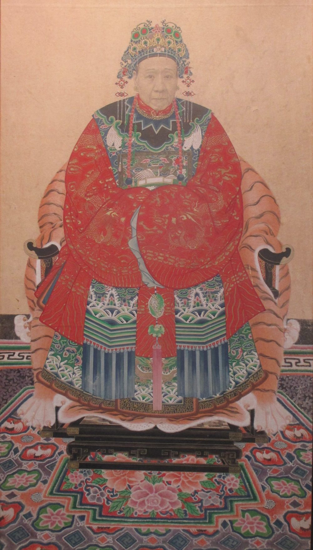 A Chinese ancestral portrait, the sitter seated wearing an elaborate ...