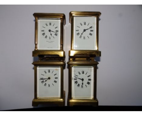 A  French brass carriage clock retailed by Mappin &amp; Webb together with three other brass carriage clocks all with damage 