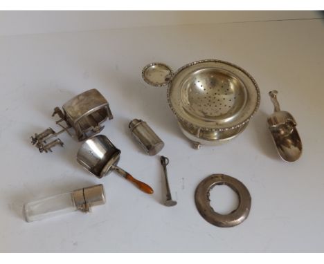 A silver tea strainer on stand - Birmingham 1946,  a Georgian Birmingham silver caddy spoon, a plated sugar scoop and five ot