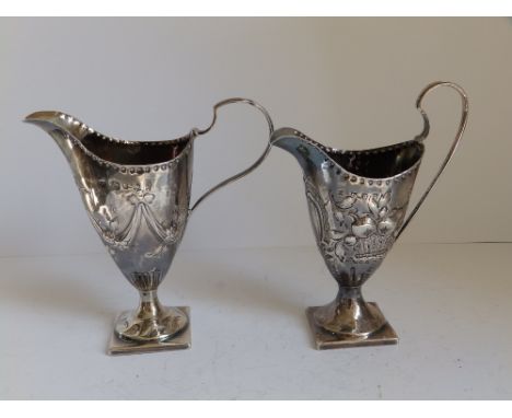 Two 18thC  silver helmet shaped cream jugs each on square pedestal foot - Charles Hougham, London. 5.5" high. 