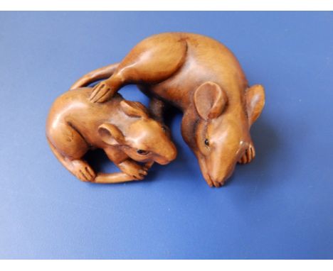 A 20thC signed Japanese wood netsuke carved to depict two mice.