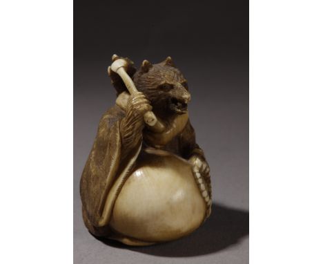 A 19th century Japanese netsuke. Signed Gyokobun on the base. In carved elephant ivory portraying "Tanuki" sat with a bloated