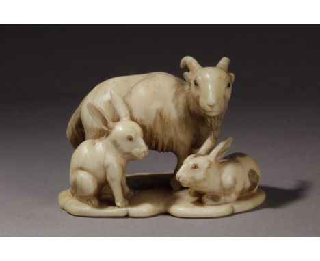 A 19th century Japanese netsuke. Signed Yasumin on the base. In carved elephant ivory portarying a goat with horn eyes and a 