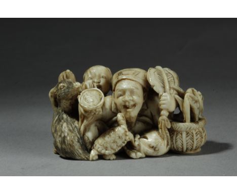 A 19th century Japanese netsuke from Meiji period. In carved ivory portraying a group of figures composed by Jurojin, a girl,