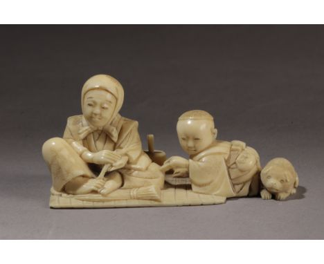 A mid 19th century Japanese netsuke okimono from Edo period. Signed Masatsugu on the base. In carved ivory depicting a group 