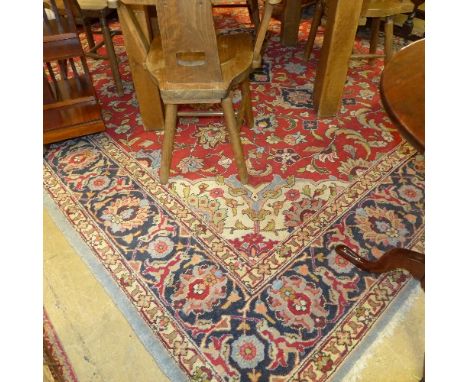 A Persian hand knotted carpet the rouge ground with floral single border