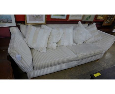 A multiyork large two seater/ three seater sofa upholstered in beige fabric on castor and cushions W 257 D 100 H 88 cm