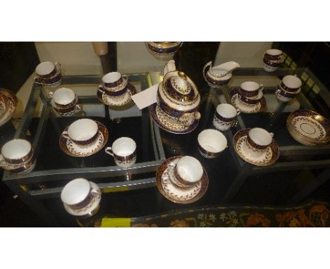 A late Victorian porcelain tea service the blue border with allover gilded detail