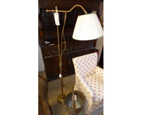 A brass antique reading light with a brass coal scuttle 
