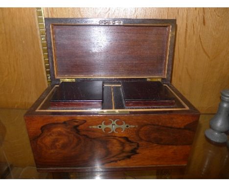 A Georgian rosewood tea caddy with brass handles containing two lidded compartments 